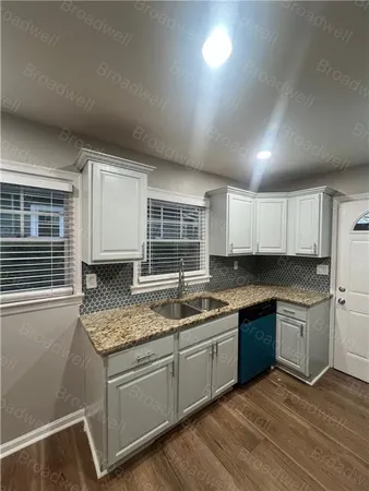 a kitchen with stainless steel appliances granite countertop a sink stove and cabinets