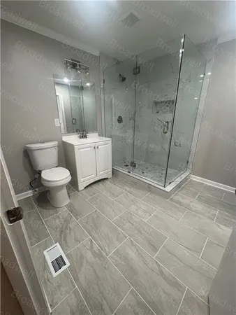 a bathroom with a toilet sink and shower