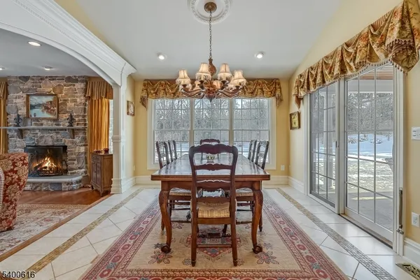 a dining room with furniture a chandelier and wooden floor