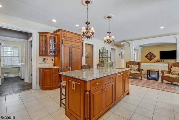 a kitchen with stainless steel appliances kitchen island granite countertop a stove top oven and cabinets