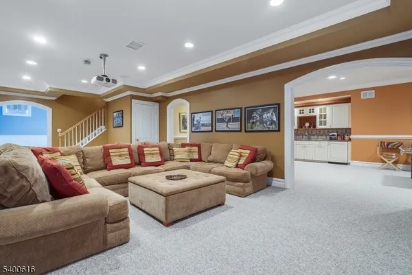 a living room with furniture and kitchen view