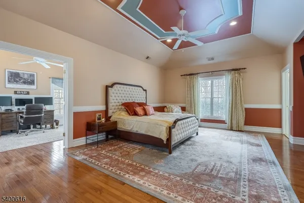 a bedroom with a bed lamps and chairs
