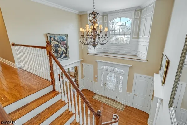 a view of a livingroom with wooden floor and stairs