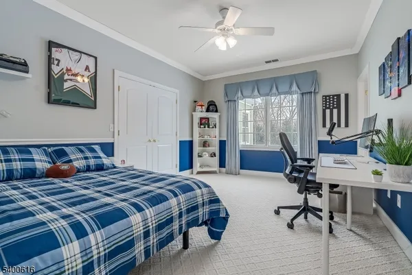 a bedroom with a bed and a desk