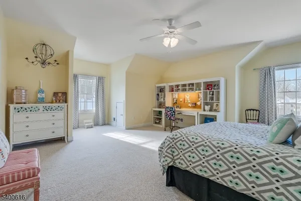 a spacious bedroom with a bed and a couch