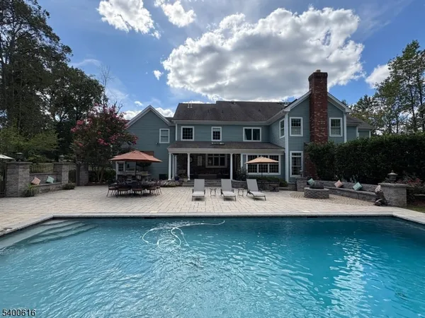 a house view with swimming pool and garden space