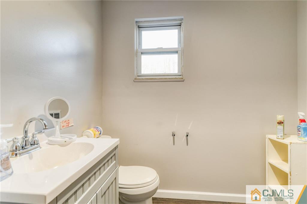 1896 Englishtown Road Old Bridge, NJ 08831 - Photo 10 of 16 a bathroom with a sink toilet and vanity