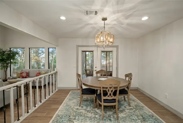 a view of a dining room with furniture wooden floor and chandelier