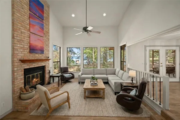 a living room with furniture a fireplace and a chandelier