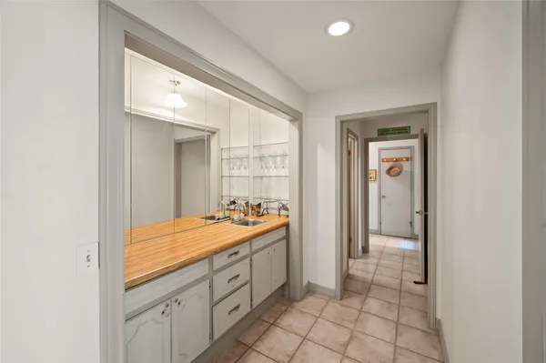 a spacious bathroom with a sink a mirror and a shower