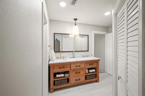 a bathroom with a double vanity sink and a mirror