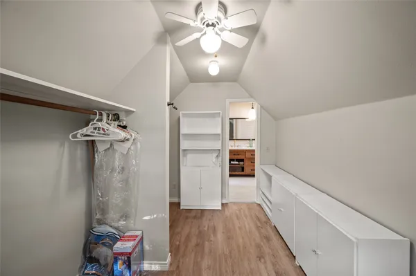 a view of a hallway with wooden floor and workspace