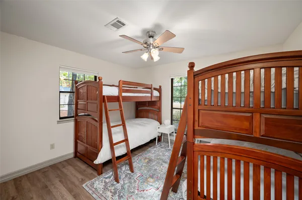a bedroom with furniture and a ceiling fan