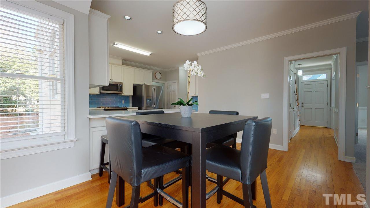 4708 Alistar Court Raleigh, NC 27612 - Photo 11 of 30 a view of a dining room with furniture and wooden floor