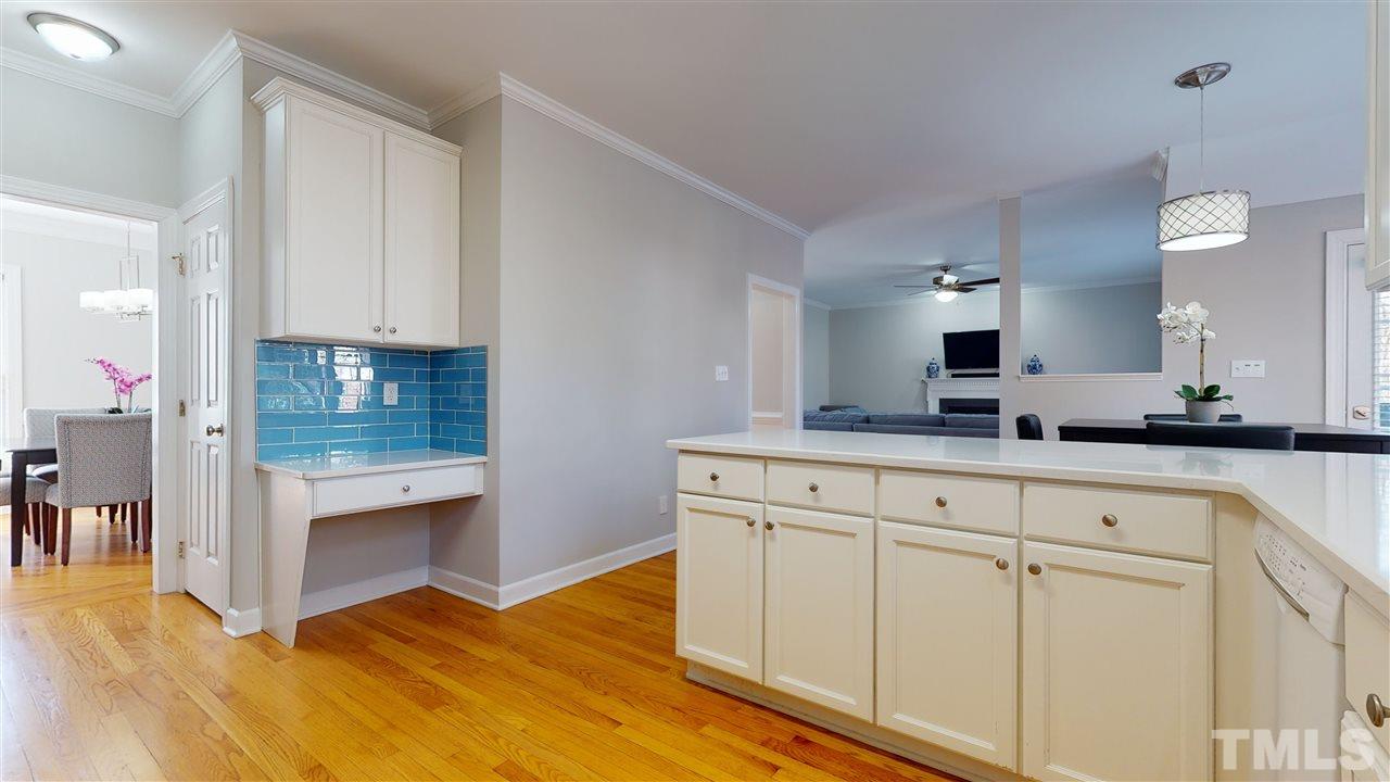 4708 Alistar Court Raleigh, NC 27612 - Photo 15 of 30 a kitchen with granite countertop white cabinets and white appliances
