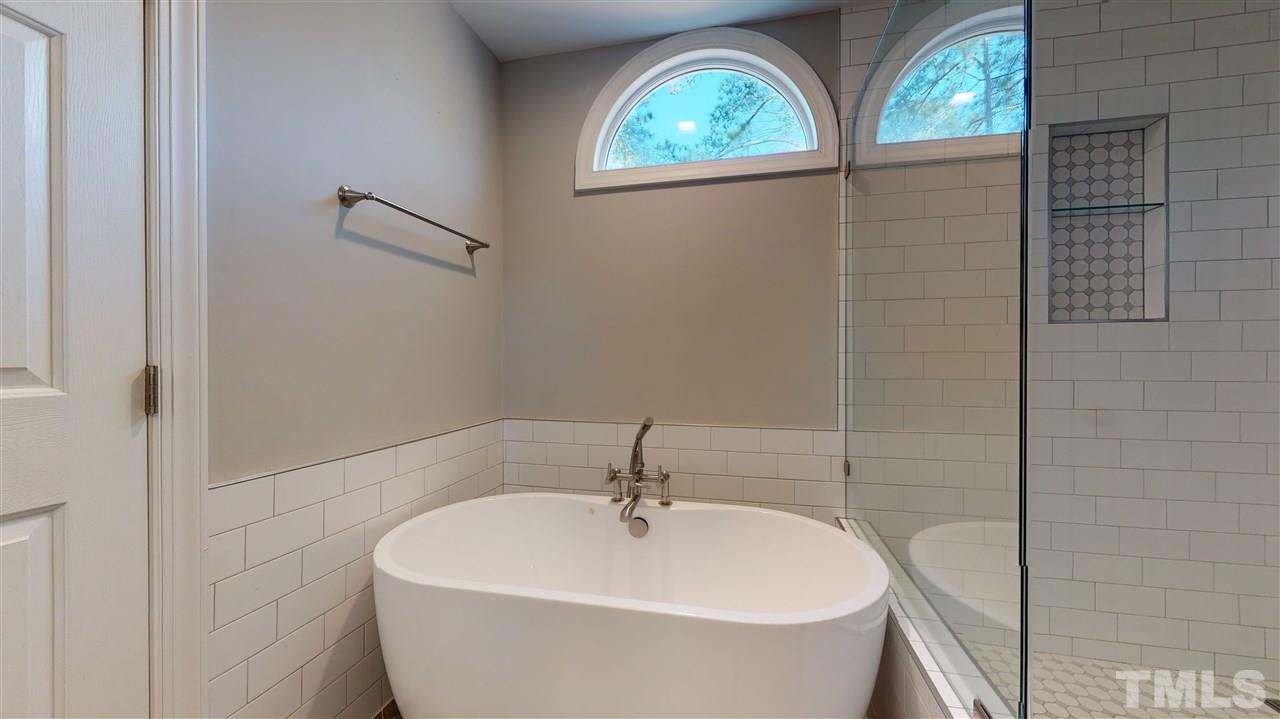 4708 Alistar Court Raleigh, NC 27612 - Photo 20 of 30 a bathroom with a white bath tub and a window