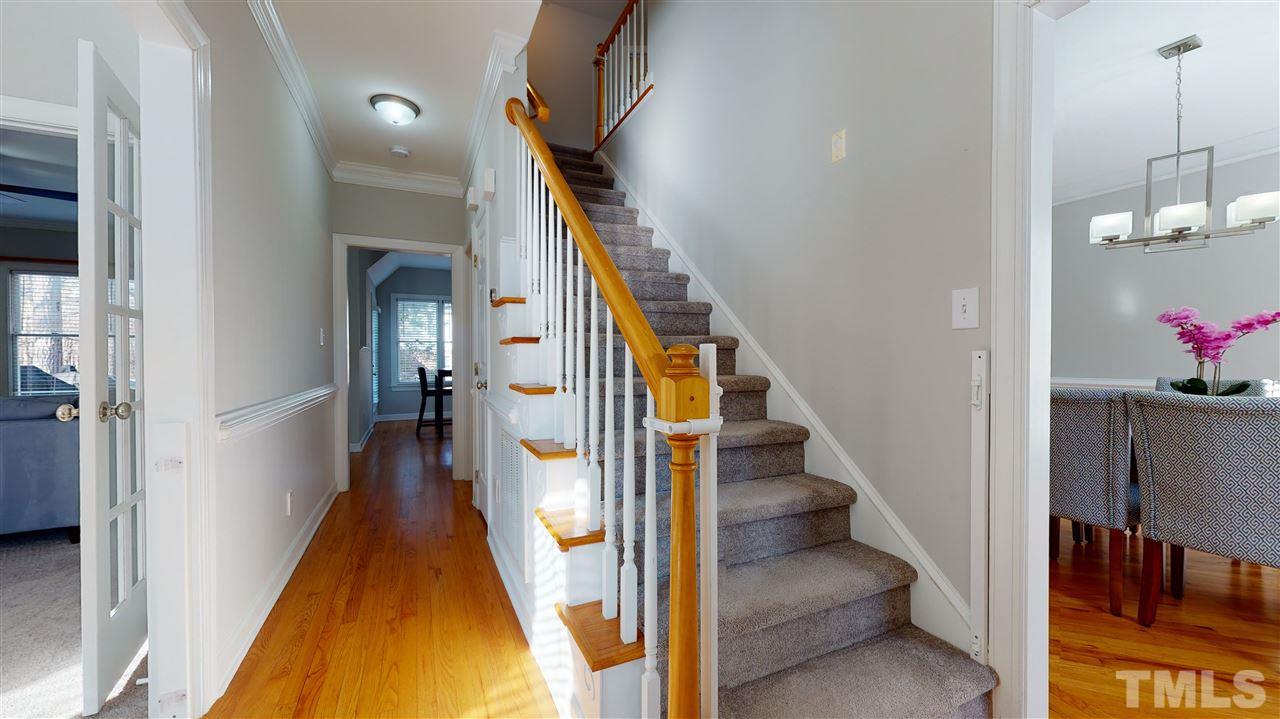4708 Alistar Court Raleigh, NC 27612 - Photo 3 of 30 a view of a hallway with wooden floor and staircase