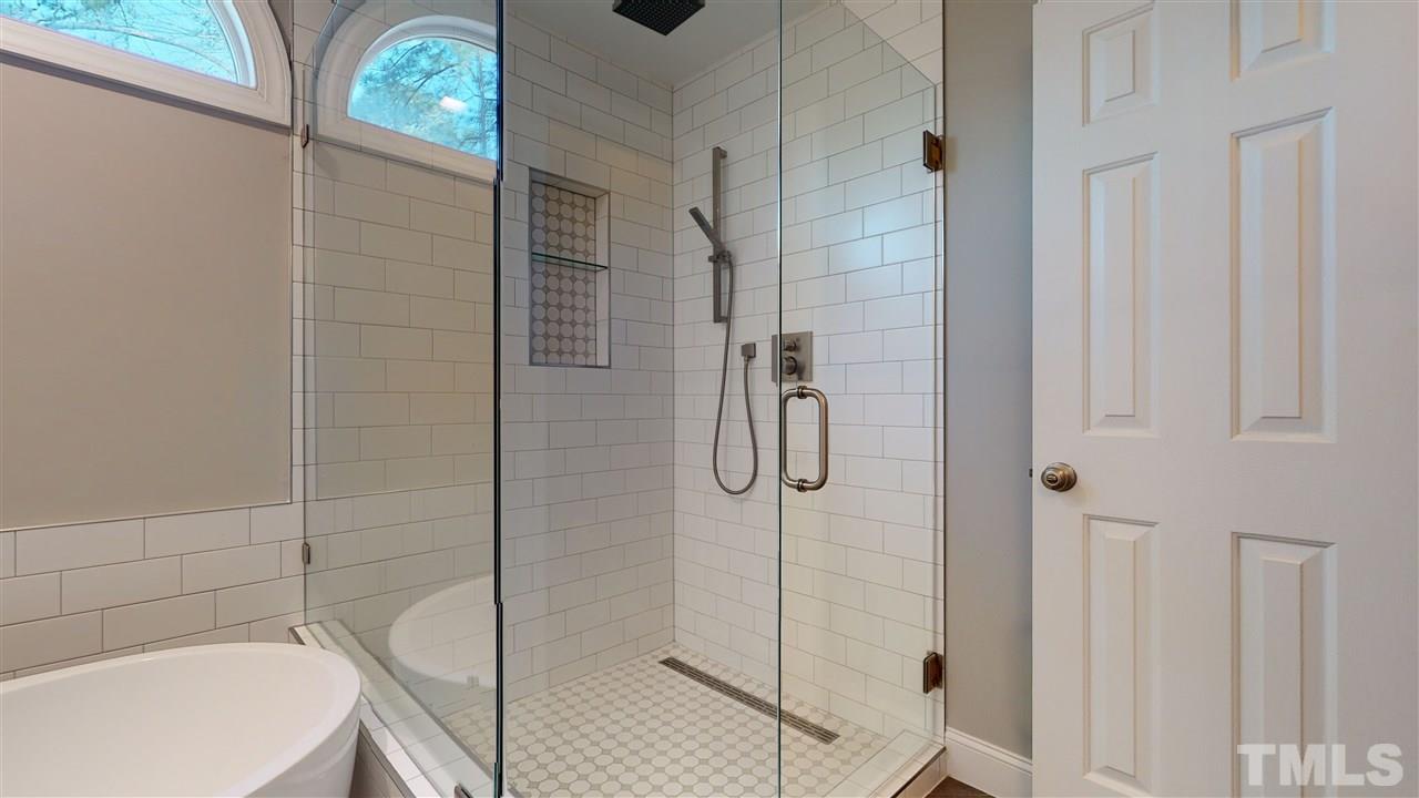 4708 Alistar Court Raleigh, NC 27612 - Photo 21 of 30 a bathroom with a bathtub and shower