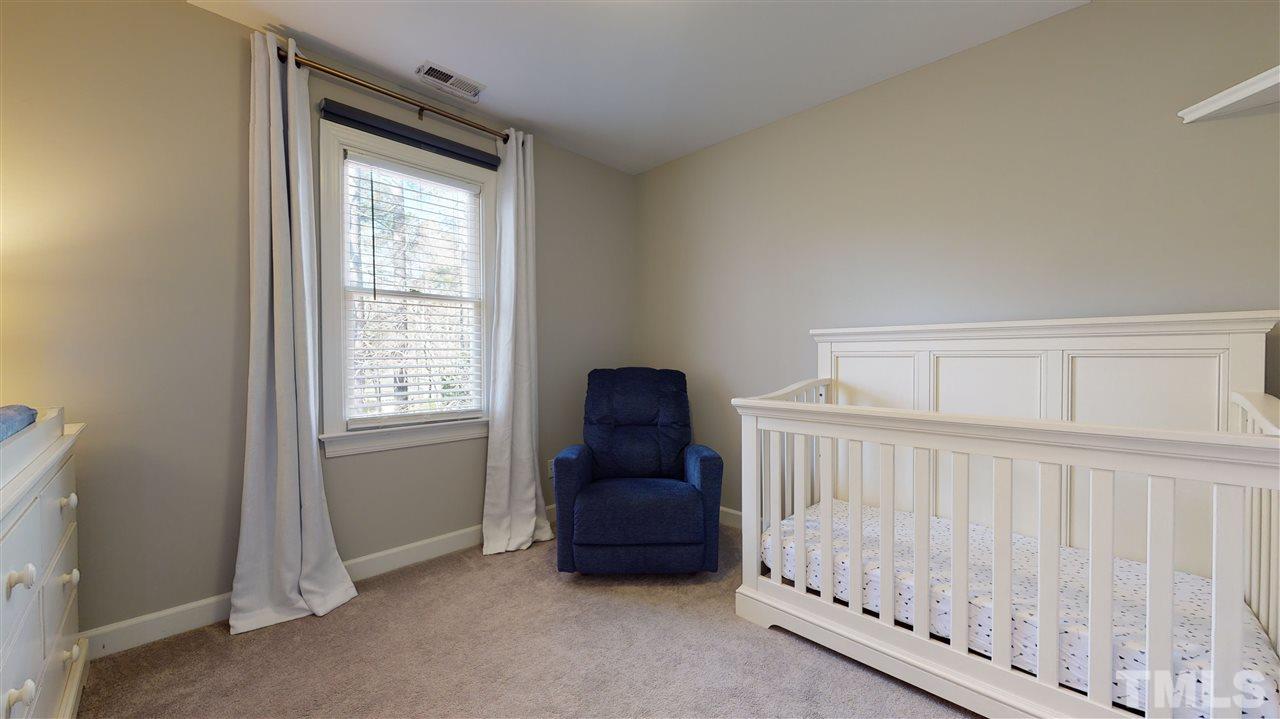 4708 Alistar Court Raleigh, NC 27612 - Photo 23 of 30 a living room with a baby crib furniture and a window