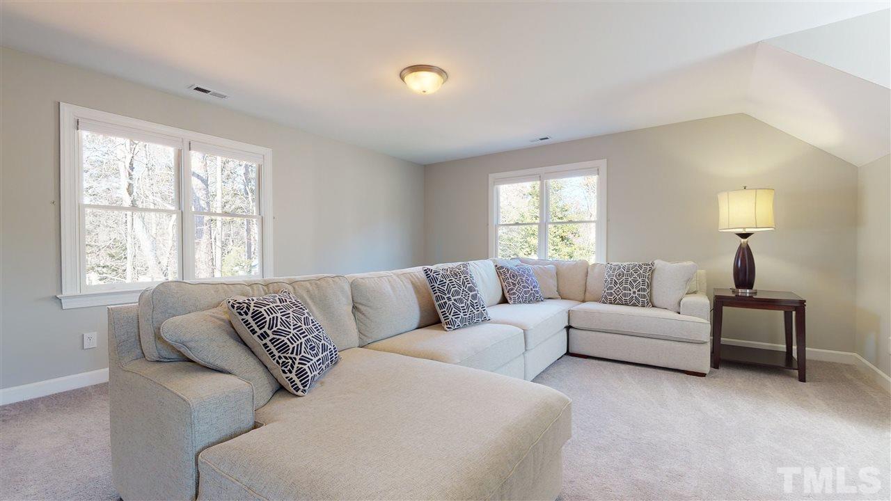 4708 Alistar Court Raleigh, NC 27612 - Photo 24 of 30 a living room with furniture and a large window