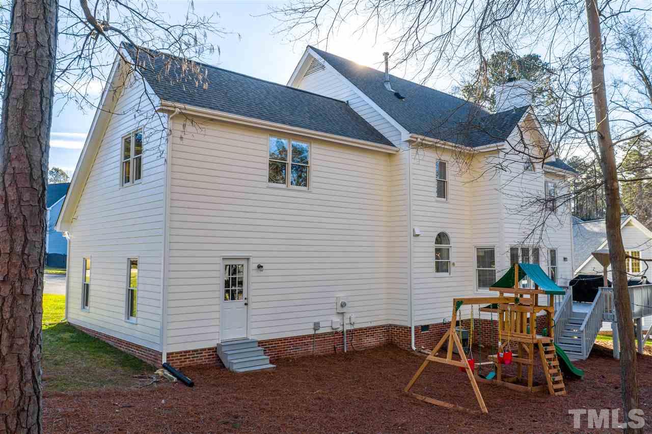 4708 Alistar Court Raleigh, NC 27612 - Photo 30 of 30 a view of a white house with a small yard and a large tree