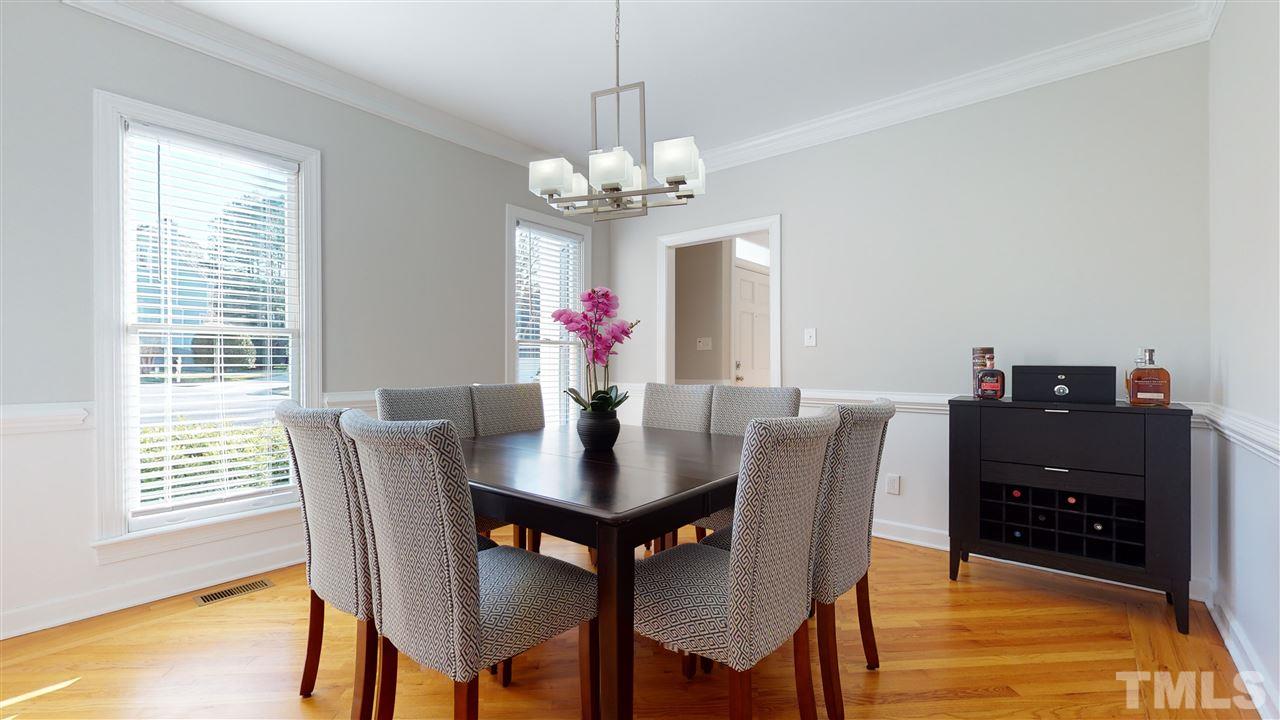 4708 Alistar Court Raleigh, NC 27612 - Photo 7 of 30 a view of a dining room with furniture window and wooden floor
