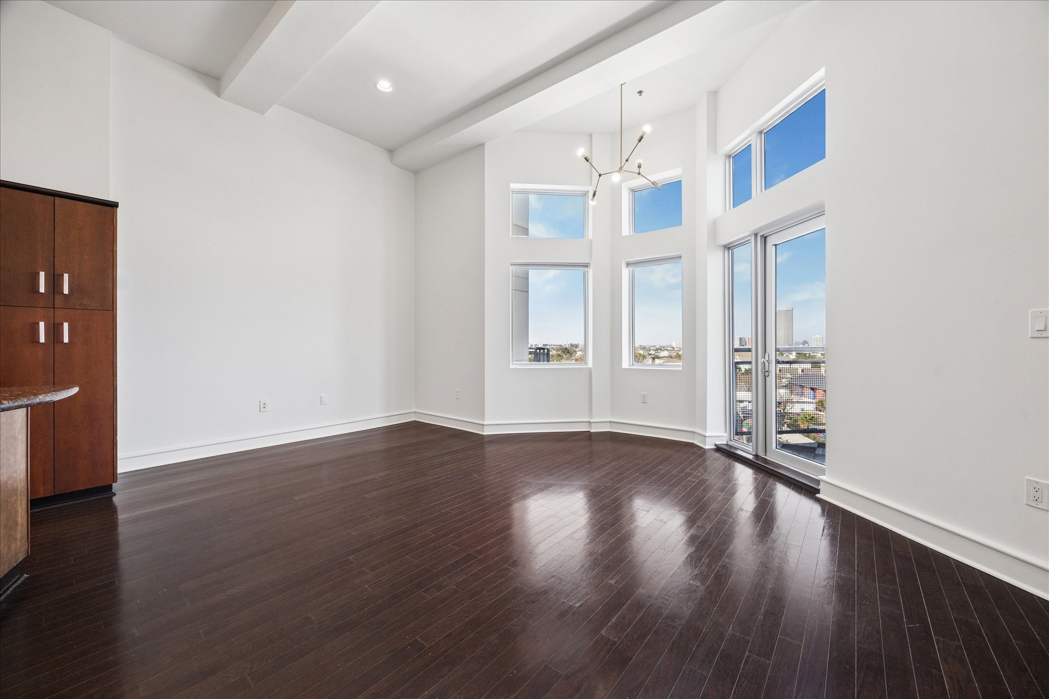 3311 Yupon Street, Unit 609 Houston, TX 77006 - Photo 3 of 16 a view of an empty room with wooden floor and a window