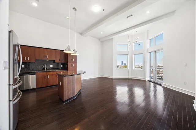 a view of a kitchen with furniture and wooden floor