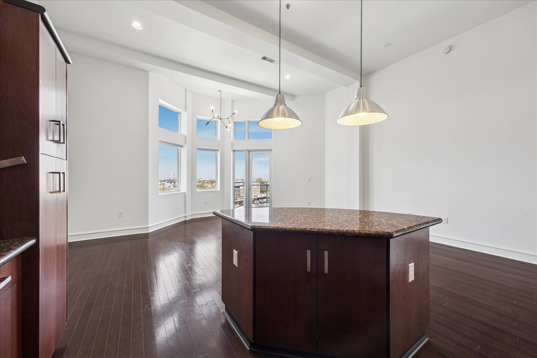 3311 Yupon Street, Unit 609 Houston, TX 77006 - Photo 8 of 16 a kitchen with stainless steel appliances granite countertop a sink a window and wooden floor
