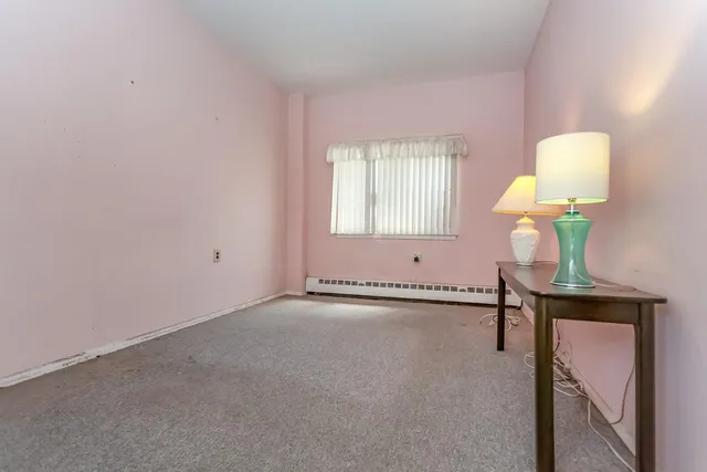 a view of an empty room and a window