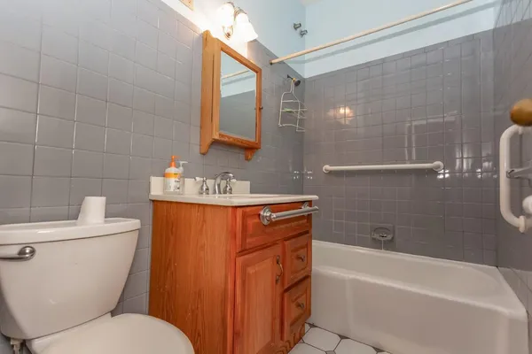 a bathroom with a granite countertop toilet a sink and bathtub