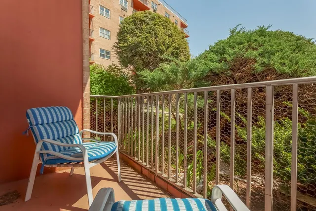 a view of a chair and table in the balcony