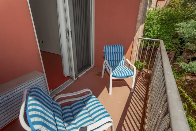 a view of two chairs in the balcony