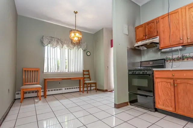 a kitchen with granite countertop a stove a sink and a microwave