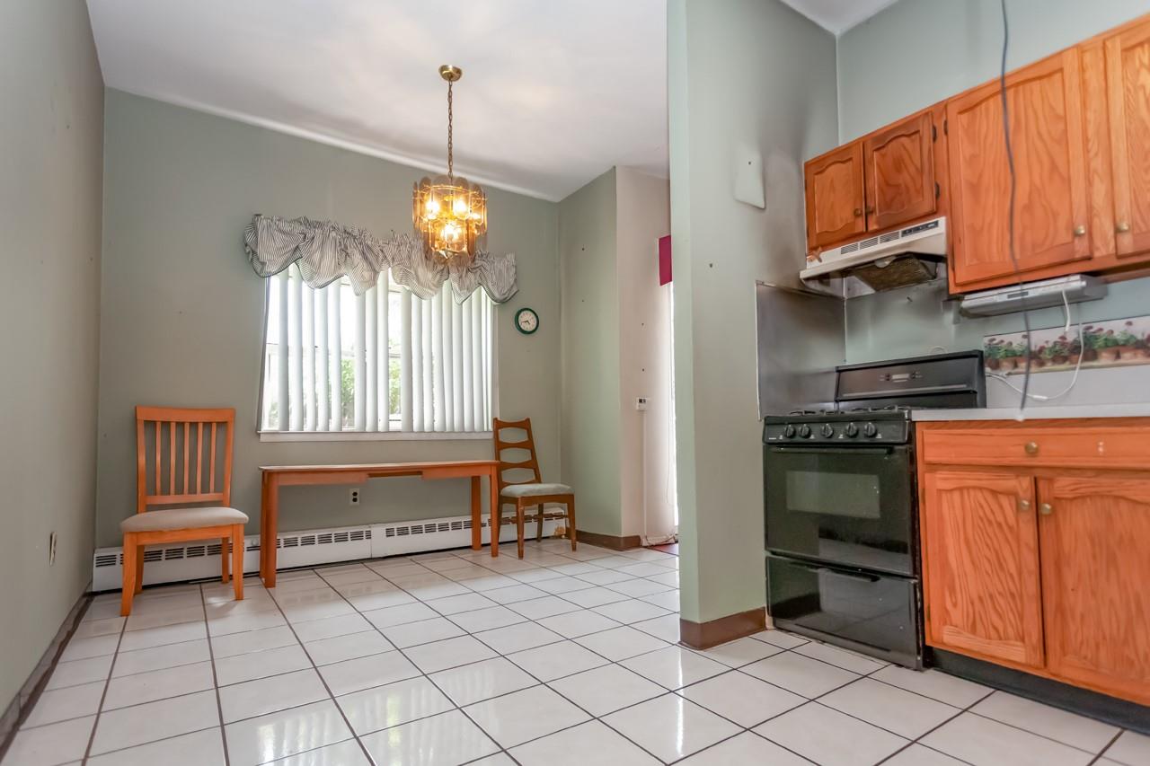 1 Lakeview Drive, Unit LL5 Peekskill, NY 10566 - Photo 5 of 23 a kitchen with granite countertop a stove a sink and a microwave