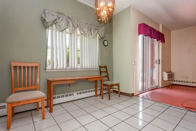 a living room with furniture and a chandelier