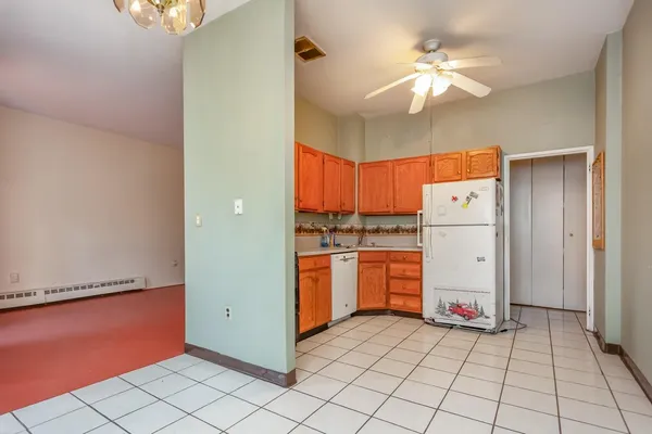 a kitchen with stainless steel appliances granite countertop a refrigerator a sink and dishwasher