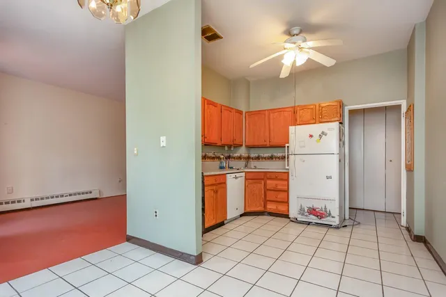 a kitchen with stainless steel appliances granite countertop a refrigerator a sink and dishwasher