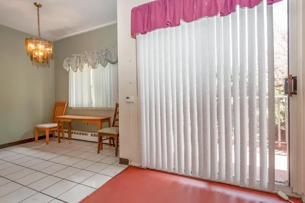 a view of a room with a window and furniture