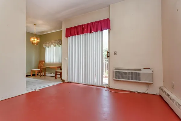 a view of a livingroom with lounge chair and a window