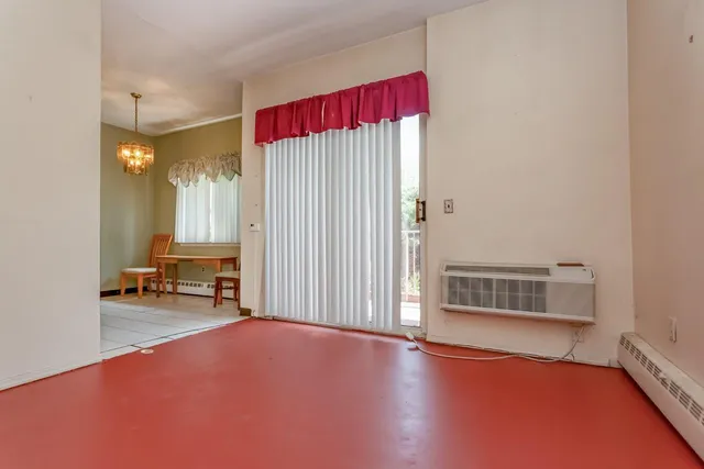 a view of a livingroom with lounge chair and a window