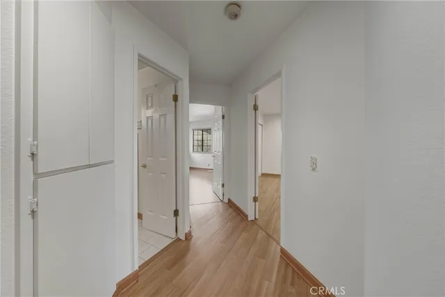 a view of a hallway with wooden floor