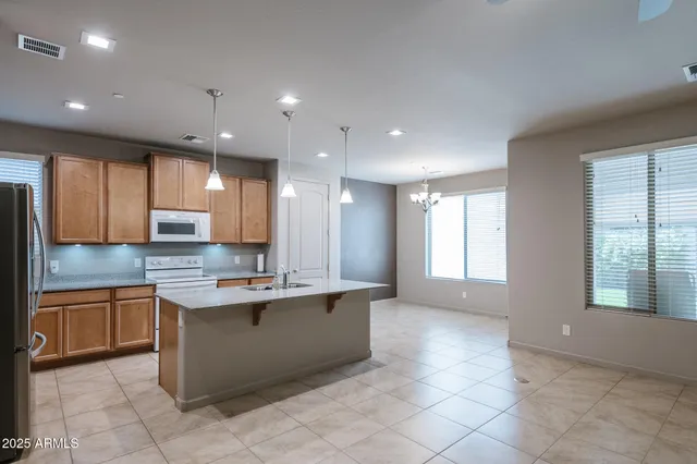 a kitchen with kitchen island sink cabinets and window
