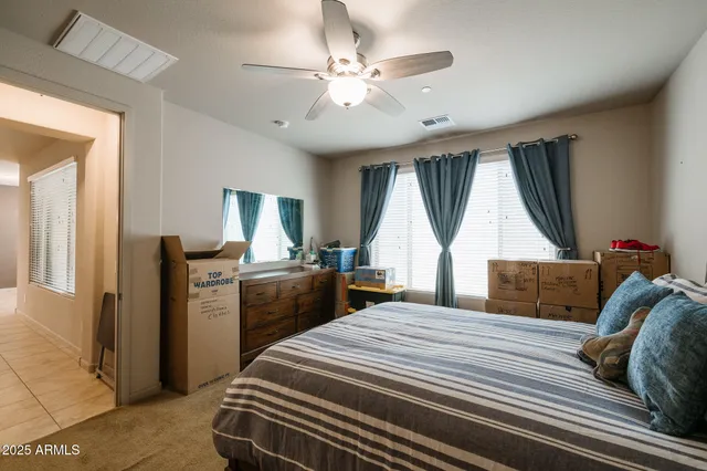a bedroom with a bed and a large window