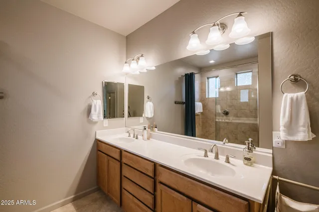a bathroom with a double vanity sink and a mirror