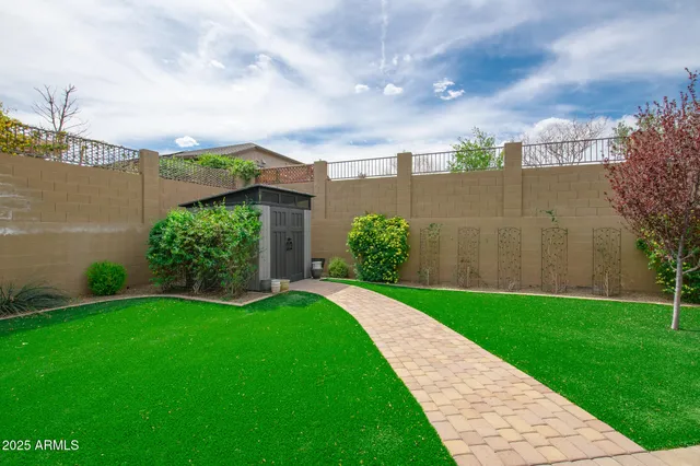 a view of a garden with a building in the background