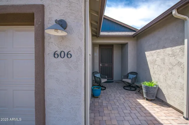 a view of a door and chair in wooden floor