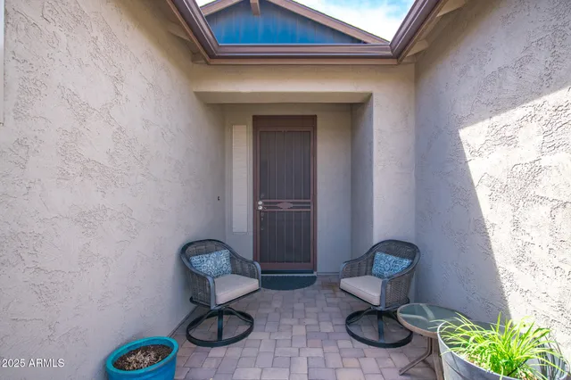 a view of that has two chairs and a potted plant