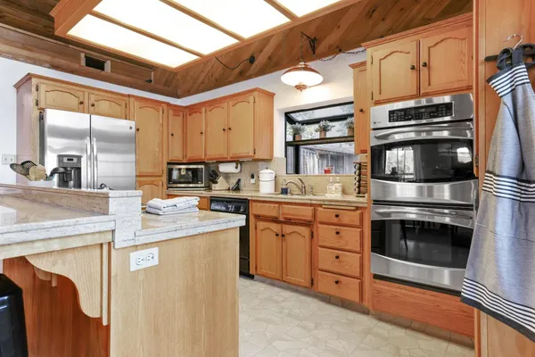 a view of a hallway with dining area and chandelier