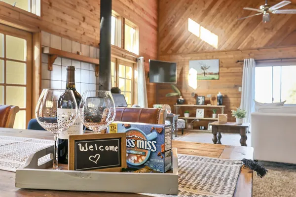 a bedroom with a bed a flat screen tv and a dresser